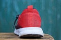 The back of one sneaker made of red fabric and a white sole Royalty Free Stock Photo