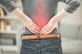 Back, pain and backache of a woman touching and holding a painful area on her body highlighted in red. Closeup of a Royalty Free Stock Photo