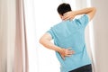 Back pain, man with backache at home