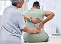 Back pain, physical therapy and chiropractor with patient, spine injury and healthcare with help and people at clinic Royalty Free Stock Photo