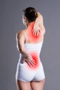 Back pain, woman with backache on gray background Royalty Free Stock Photo