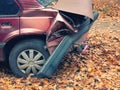 Back part of car after crash accident. closeup side shot of smashed crumpled rear bumper and flat tire. fall autumn season. road Royalty Free Stock Photo