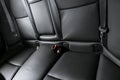 Back passenger seats in modern luxury car, frontal view. Black perforated leather with white stitching. Car detailing. Leather com Royalty Free Stock Photo