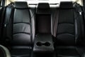 Back passenger seats in modern luxury car, frontal view, black perforated leather, Luxury car inside. Interior of prestige modern Royalty Free Stock Photo