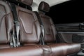 Back passenger seats in modern luxury car. Frontal view. Brown perforated leather with white stitching. Car detailing. Back Leathe Royalty Free Stock Photo