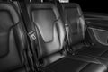 Back passenger seats in modern luxury car. Frontal view. Perforated leather with white stitching. Car detailing. Back Leather comf Royalty Free Stock Photo