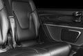 Back passenger seats in modern luxury car. Frontal view. Perforated leather with white stitching. Car detailing. Back Leather comf Royalty Free Stock Photo