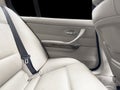 Back passenger white leather seats in modern luxury car. White perforated leather with stitching. Car inside. Leather comfortable