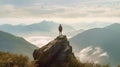 Back of person standing on rock looking out on mountain landscape