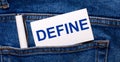 The back pocket of blue jeans contains a white pen and a white card with the text DEFINE Royalty Free Stock Photo