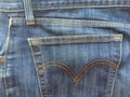 Back pocket of boiled retro jeans in blue.