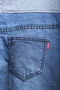 Back pocket of denim trousers. with ripped denim jeans close up for pregnant women