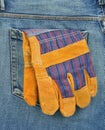 Back pocket of jeans with protective gloves Royalty Free Stock Photo