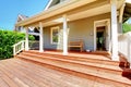 Back porch of small grey house with bench Royalty Free Stock Photo