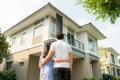 Back portrait of Asian young couple standing and hugging together looking happy in front of their new house to start new life. Royalty Free Stock Photo