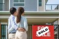 Back portrait of Asian young couple standing and hugging together looking happy in front of their new house to start new life. Royalty Free Stock Photo