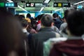 Back portrait crowd of passengers waiting for entering at the entrance of subway station during rush hours in morning