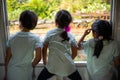 Back portrait of three sisters looking out the window of the train Royalty Free Stock Photo