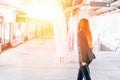 Back of professional businesswoman in black formal suit with luggage going for business travel trip. Royalty Free Stock Photo