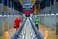 Back of professional engineer and technician stand near railroad tracks of electrical or sky train and discuss about accessories Royalty Free Stock Photo