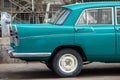 Back or rear Half of a Vintage Car parked outside a repair work