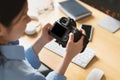 Portrait Of Asian Woman Holding Photo Camera Looking At Screen Royalty Free Stock Photo