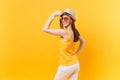 Back rear portrait view of young woman in straw summer hat, orange glasses put hands on head, copy space isolated on