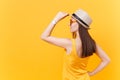 Back rear portrait view of young woman in straw summer hat, orange glasses put hands on head, copy space isolated on