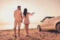 Back rear view full body photo of young couple seaside journey car transport point indicate finger date romantic summer Royalty Free Stock Photo