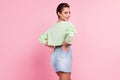 Back rear view photo of young cheerful girl happy positive smile wear casual outfit isolated over pink color background