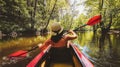 Back Rear View strong caucasian woman rowing Kayaking In Beautiful Lithuania countryside river - Zemeina. Action Camera POV Of Royalty Free Stock Photo