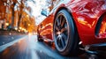 rear wheel of fast moving car with motion blur on road close-up. Luxury red sports car Royalty Free Stock Photo