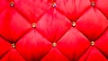 Back of a red sofa. Red fabric texture background, Chesterfield style decoration with buttons, retro fabric. Retro diamond-shaped Royalty Free Stock Photo