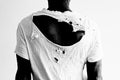 Back of a man wearing a ripped white t-shirt