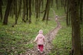 Back of running kids in spring forest path. Happy childhood moments Royalty Free Stock Photo