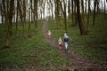 Back of running kids in spring forest path. Happy childhood moments Royalty Free Stock Photo