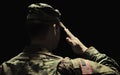 Back, salute and army with a soldier in uniform on a dark background in studio for service or duty as a patriot Royalty Free Stock Photo