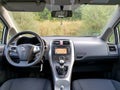 Back seat view over car dashboard, touchscreen navigation display, manual gear transmission