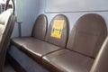 The back seats of a bus with a sign encouraging social distancing during the coronavirus outbreak