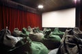 Back of seats like sacks and screen in movie theater. Royalty Free Stock Photo