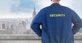 Back of security guard against blurry skyline