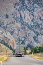 Back of a semi truck driving in the Montana rocky mountains Royalty Free Stock Photo