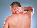 Back, senior man and neck pain with stress, emergency and guy against blue studio background. Mature male, gentleman and