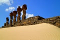 Back of seven Moai statues of Ahu Nau Nau ceremonial platform surrounded by soft coral sand of Anakena beach, Easter Island Royalty Free Stock Photo