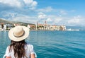 Back shot of Female tourist looking at townscape of beautiful seaside town of Trogir in Croatia Royalty Free Stock Photo