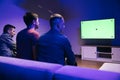Back Shot of a Gamers Playing and Winning in Online Video Game on His console with Green Chroma Key Screen Personal TV Royalty Free Stock Photo