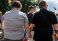 Back shot of a gay couple holding hands at the LGBTQ pride march in Bratislava, Slovakia