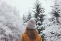 back shot, woman facing snowcovered trees