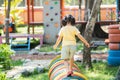 Back side. Asian girl play on school or kindergarten yard or playground. Healthy summer activity for children. Little asian girl Royalty Free Stock Photo