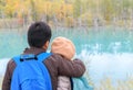 Back side of brother hugging sister at Blue pond Royalty Free Stock Photo